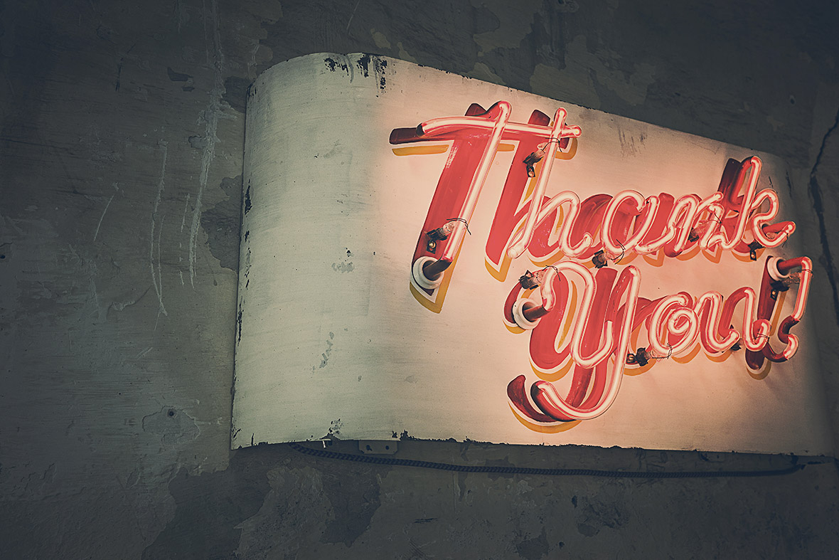 Neon "Thank You" sign on wall.
