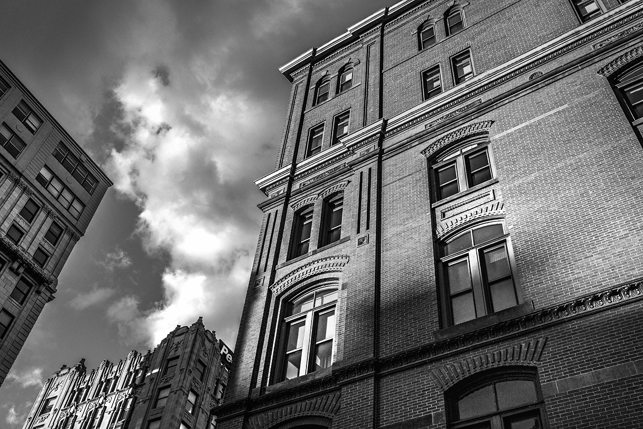 Historic brick building under cloudy sky.