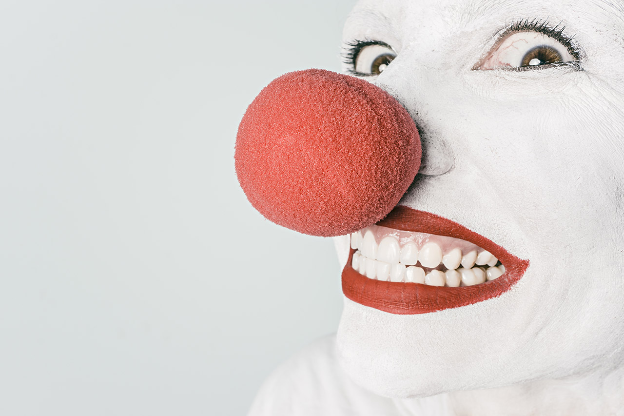 Close-up of clown with red nose.